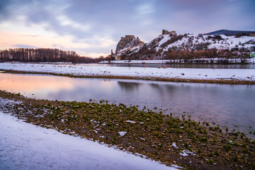 Snow Covered Devin Castle Ruins above the Danube River in Bratislava, Slovakia at Sunrise