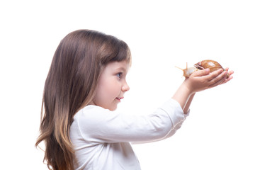 Attractive little girl is holding a Akhatina snail. Isolated on white background. Close up. Concept of youth and beauty skin, facial rejuvenation