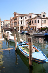 Fototapeta na wymiar Typical houses of the Venetian lagoon overlooking a canal in Chioggia - Italy