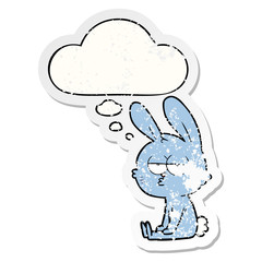 cute cartoon rabbit and thought bubble as a distressed worn sticker