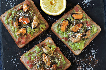 Healthy toasts with avocado paste and mussels. Keto diet. Keto toasts