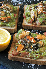 Healthy toasts with avocado paste and mussels. Keto diet. Keto toasts