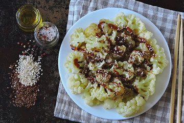 Cauliflower with soy sauce and sesame in the Chinese style. Vegan lunch