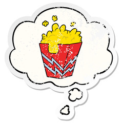 cartoon box of popcorn and thought bubble as a distressed worn sticker