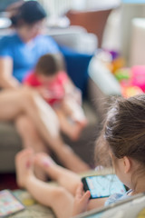 Multi-racial family getting screen time watching content on a cell phones