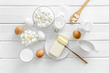 Eggs, butter, milk, yougurt, cottage for natural farm products yougurt on white wooden background top view monochrome