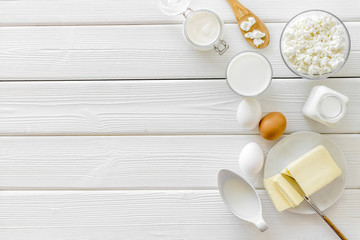 Eggs, butter, milk, yougurt, cottage for natural farm products yougurt on white wooden background top view copyspace