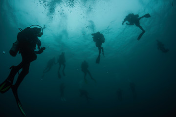 Fototapeta na wymiar Divers ascend from the deep after a dive in the beautiful waters of Grenada, West Indies, in the Caribbean Sea.