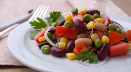 Healthy bean and corn salad on a white plate