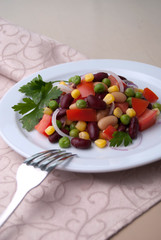 Healthy bean and corn salad on a white plate