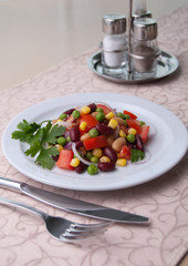 Healthy bean and corn salad on a white plate