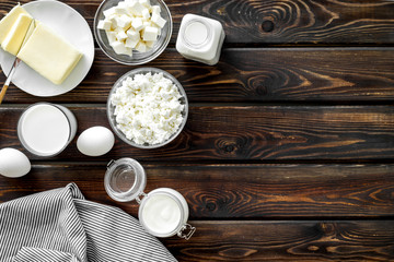 Eggs, butter, milk, yougurt, cottage for natural farm products yougurt on wooden background top view copyspace
