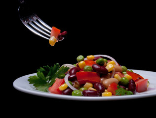 Healthy bean and corn salad on a white plate