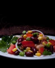 Healthy bean and corn salad on a white plate