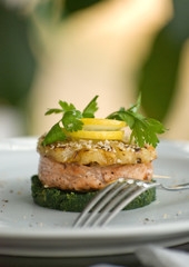 Steak fillet of red salmon fish or trout on spinach cushion.