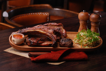 Baked ribs with suace and vagetables. Food photo for restaurant menu.