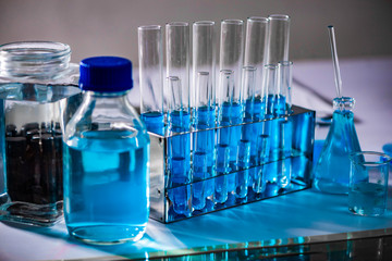 Glassware and blue liquid equipment in chemical laboratories