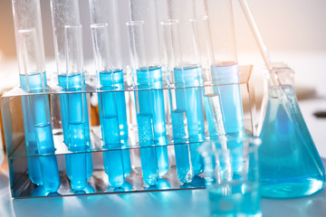 Glassware and blue liquid equipment in chemical laboratories