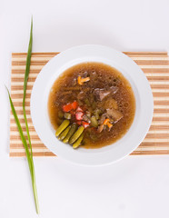 Mushroom soup in white plate from above, flat lay.