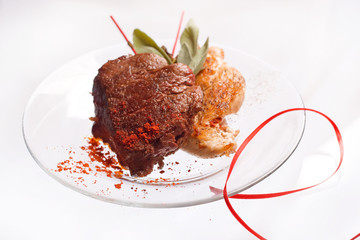 Grilled Chicken breast and Pork chop with beef meat steak and herbs in transparent plate.