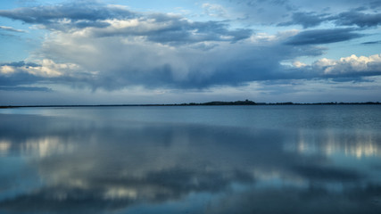 Fototapeta premium Beautiful blue background. Clouds reflected on the water. Switiaz Lake. Polesie. Ukraine