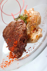 Grilled Chicken breast and Pork chop with beef meat steak and herbs in transparent plate.