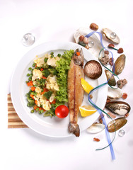 grilled fish with vegetables ona white background
