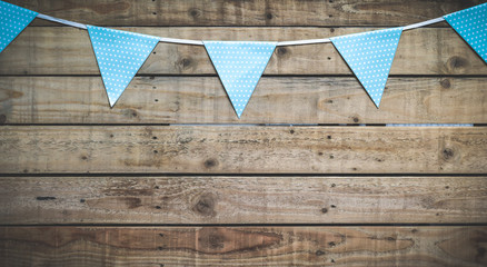 Vintage style background with bunting over wooden boards and copy space
