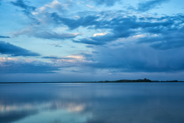 Beautiful blue background. Clouds reflected on the water. Switiaz Lake. Polesie. Ukraine