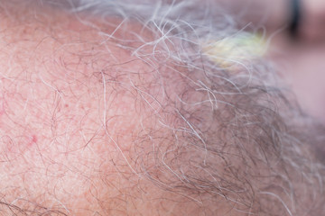 Fototapeta premium Fragments of the body of a gray-haired man