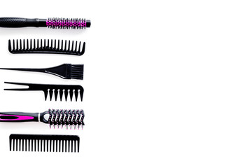 professional pink accessories of hairdresser on work desk white background top view copyspace