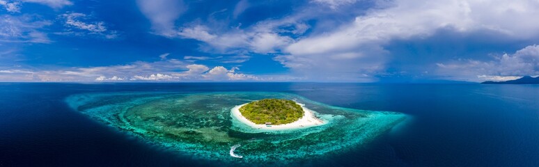 Aerial panorama of a beautiful tropical island and coral reef (Mantigue Island)