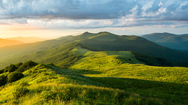 Stunning summer sunrise in the mountains. Beautiful green alpine meadow and blue sky. Polonina Wetlinska. Bieszczady. Poland