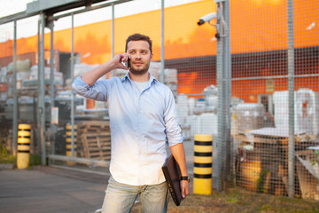 Portrait of sales representative. Logistics manager calling to his business partner to have a deal....