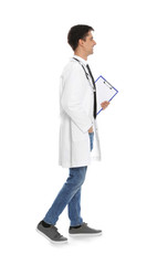 Full length portrait of medical doctor with clipboard and stethoscope isolated on white