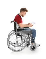 Young man in wheelchair using tablet isolated on white