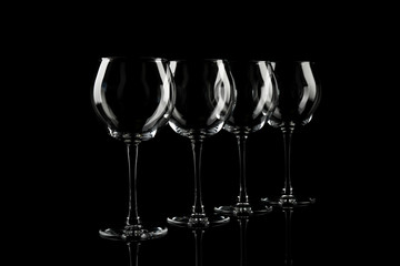 Set of empty wine glasses on black background
