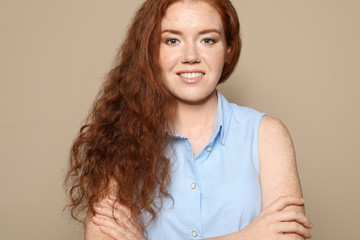 Portrait of young woman with beautiful face on beige background