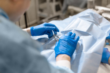 A professional ophthalmologist performs eye surgery with a microscope. The doctor inserted the...