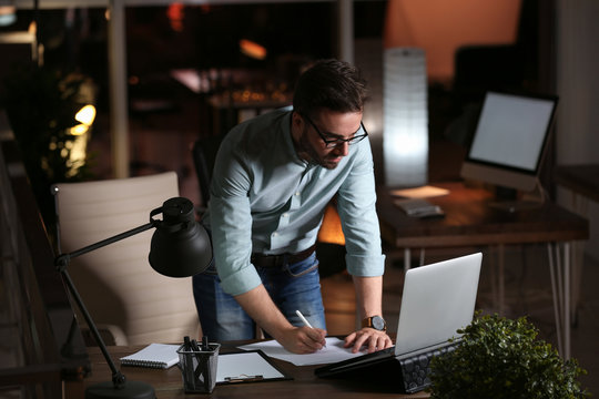 Young Man Working In Office At Night