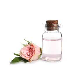 Obraz na płótnie Canvas Bottle of rose essential oil and flower isolated on white