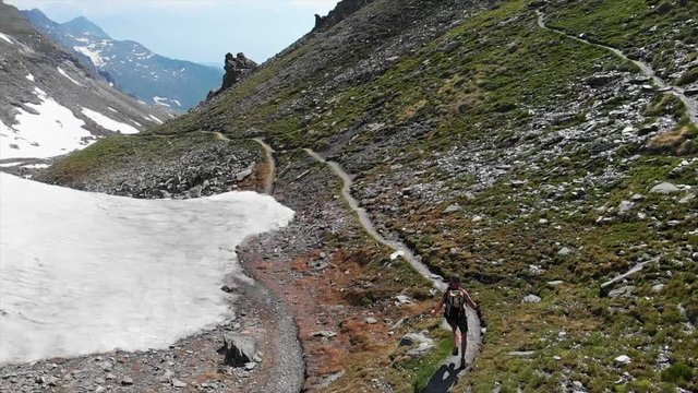 Athletic man trail running in the mountains 