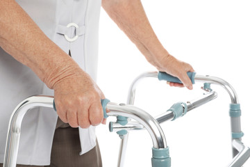 Elderly woman using walking frame isolated on white, closeup