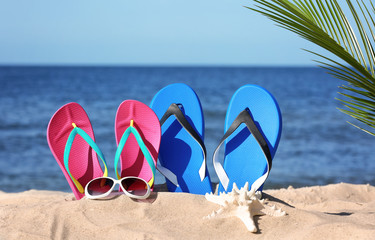 Fototapeta na wymiar Composition with beach accessories on sand near sea in summer