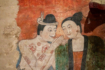 The famous mural painting of a man whispering to the ear of a woman.