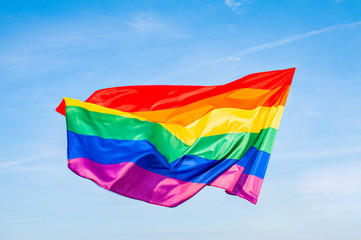 LGBT flag on blue sky. Gay Rainbow flag.