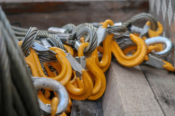 Yellow Grade 80 Sling Hooks attached to eye on Wire Rope Slings - obrazy, fototapety, plakaty