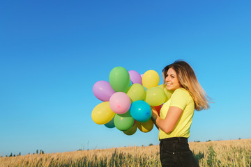 Imagination, happiness, freedom. Beautiful young girl with big bunch of colorful balloons. Birthday, party, dreamer concept