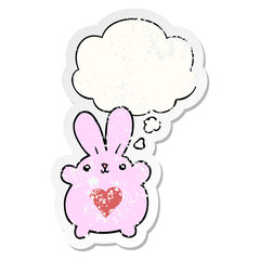 Obraz na płótnie Canvas cute cartoon rabbit with love heart and thought bubble as a distressed worn sticker