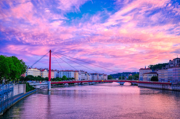 A view of Lyon, France along the Saône river at sunset.